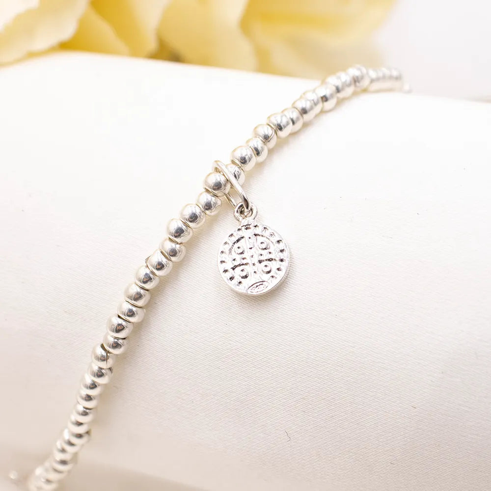 Pulsera de plata para niños con dije San Benito